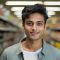 young  man happy expression in a super market. ai generated